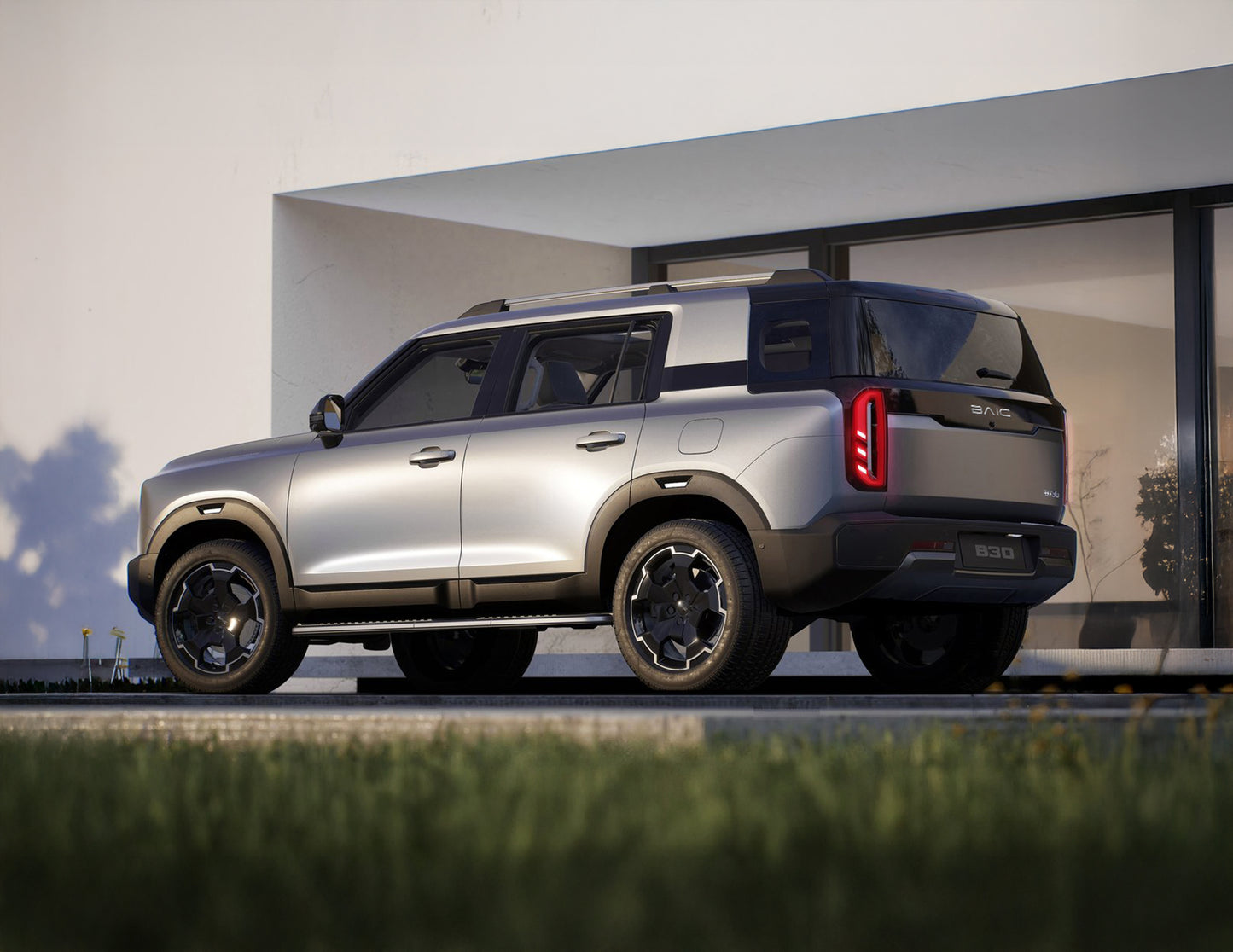 Silver SUV parked in front of a modern building with a clear sky.