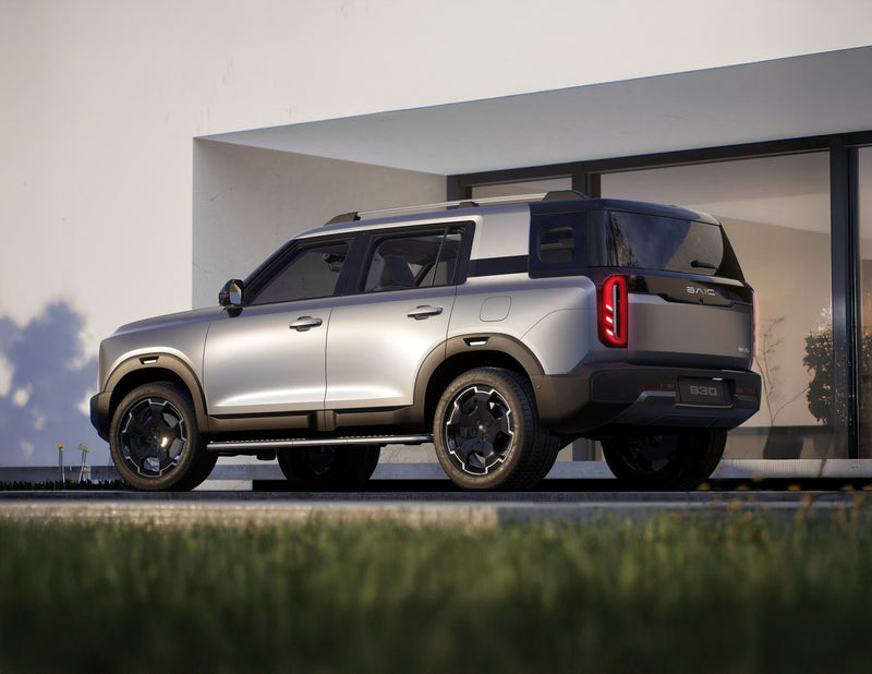 Silver SUV parked in front of a modern building with a clear sky.