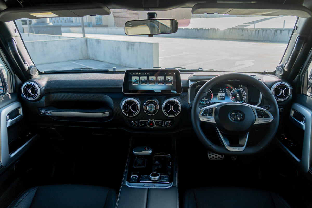 BAIC B40 Plus right-hand-drive cabin, showing the infotainment screen, turbine air vents and terrain selector